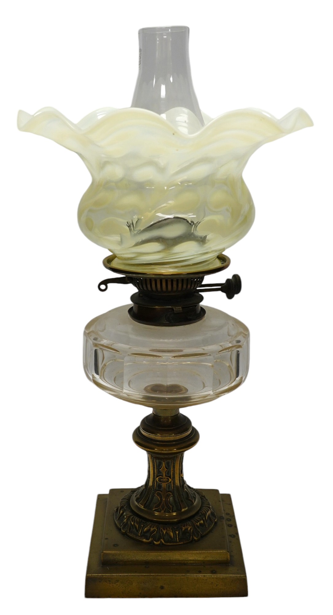 A brass oil lamp with glass reservoir and Art Nouveau vaseline glass fluted shade, 48cm high. Condition - good